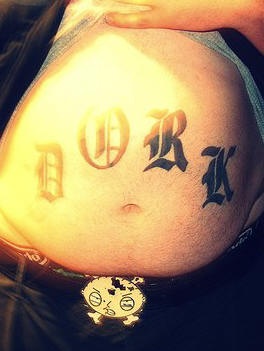 Stomach tattoo, styled word, four big letters