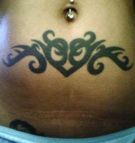 Stomach tattoo, black heart, decorated with curls