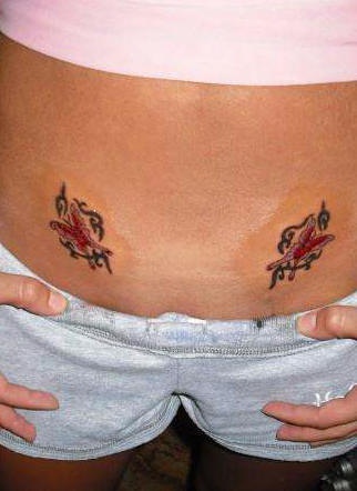 Stomach tattoo, two similar butterflies, decorated with curls