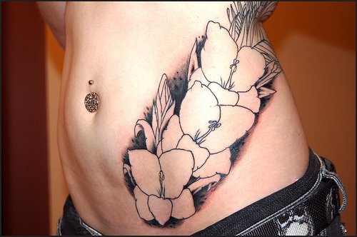 Stomach tattoo, pant with three white flowers