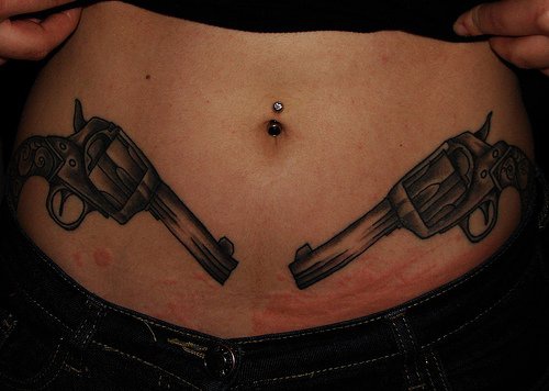 Stomach tattoo, two, black similar, symmetric guns