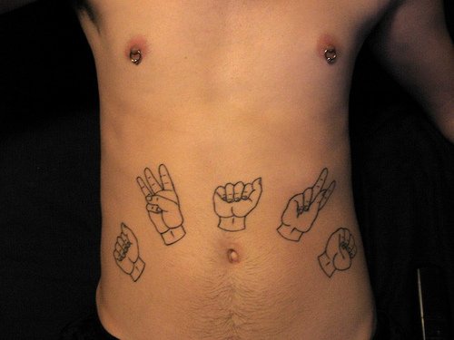 Tatuaje en vientre cinco manos mostrando diferentes dedos