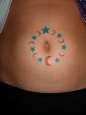 Stomach tattoo, circle around the navel of moon and stars