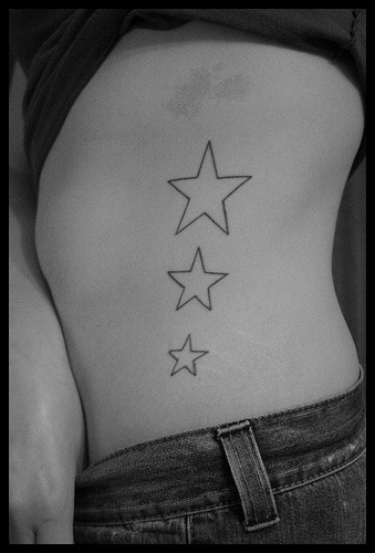 Stomach tattoo, three, unfilled, different stars