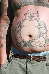 Stomach tattoo, happy, bold, fat man sitting with egg