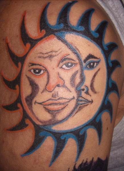Humanized sun and moon tattoo on shoulder