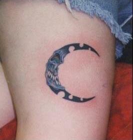 Evil moon crescent tattoo on leg
