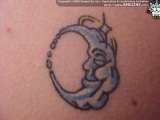 Humanized moon crescent tattoo