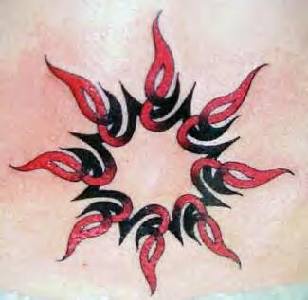 Red and black tribal sun tattoo