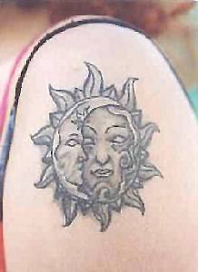 Sun and moon symbol tattoo on shoulder