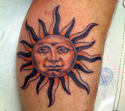 Humanized sun tattoo on arm