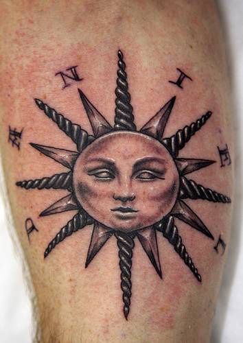 Classic sun symbol and writings tattoo