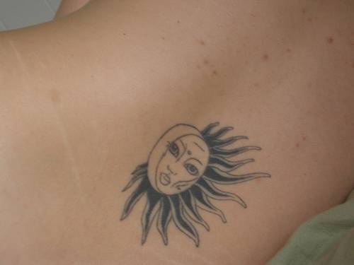 Black ink sun and moon tattoo on back