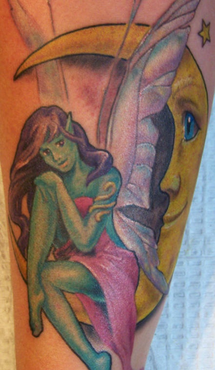 Green fairy on moon crescent tattoo