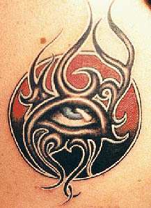 Tribal eye in sun tattoo