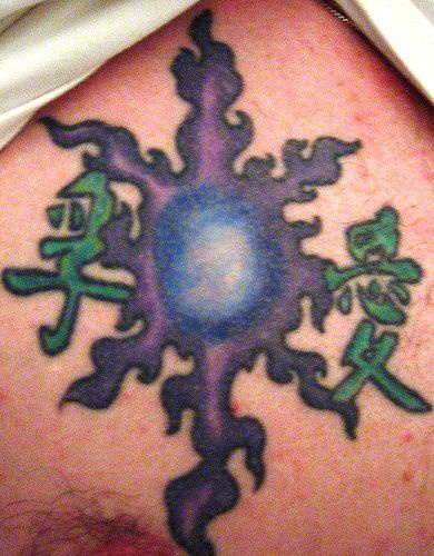 Purple sun and hieroglyphs tattoo
