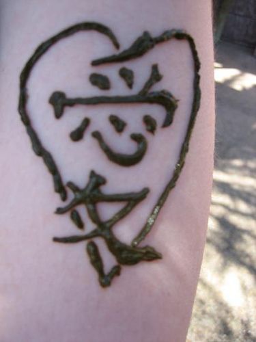 Chinese hieroglyphs in heart tattoo