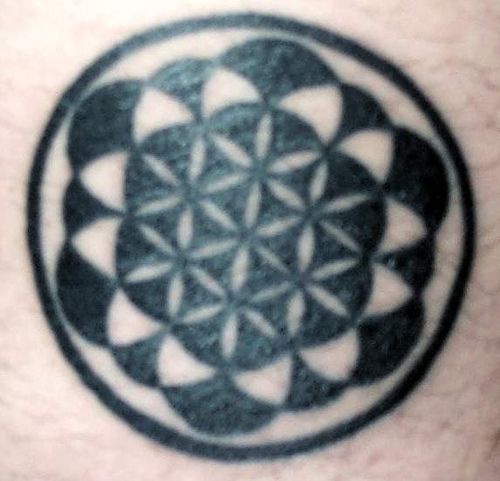 Small black ink hindu symbol tattoo