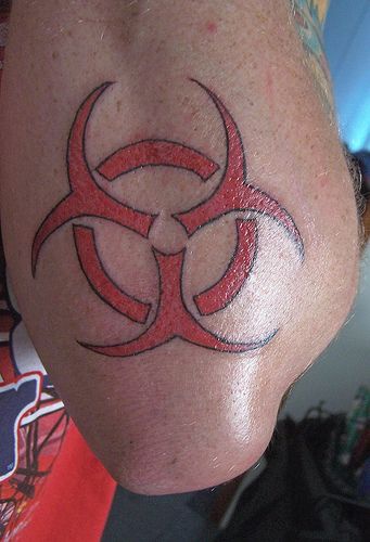 Red biohazard symbol tattoo