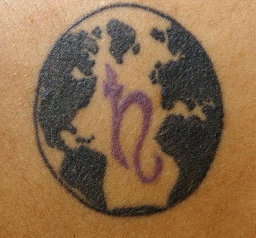 Earth with symbol tattoo