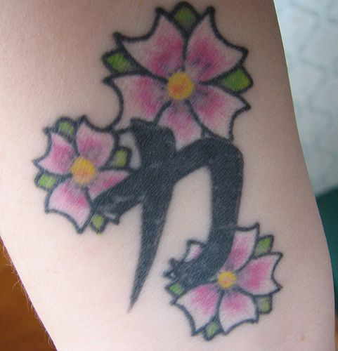 Japanese hieroglyph with flowers tattoo