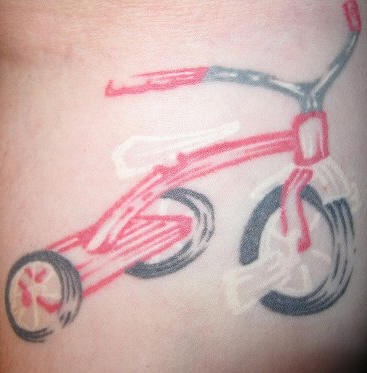 Tattoo of baby bicycle in white ink