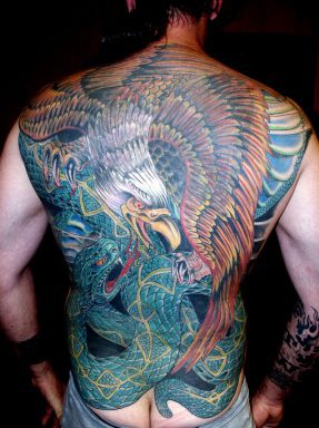 Eagle fights snake coloured tattoo on back