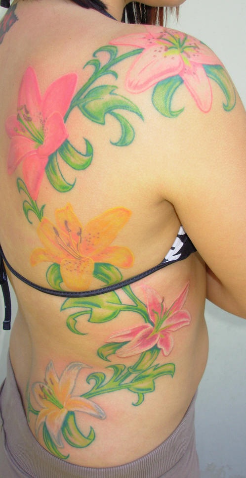 Tattoo on back and ribs, nice, pink, yellow, bright lilies