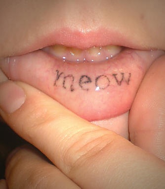 Tattoo on inisde lip, meow, little, styled word