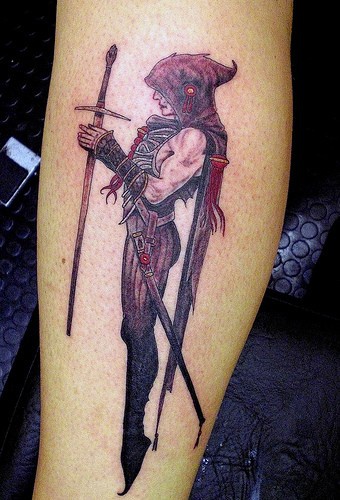 Tattoo on leg, black devil man mask with sharp gun