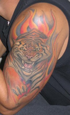 Tigre enojado entre las llamas tatuaje en color