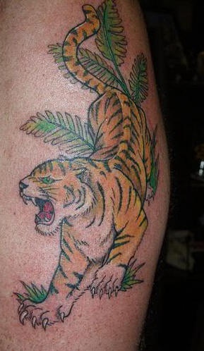 Tiger crawling through jungle  tattoo