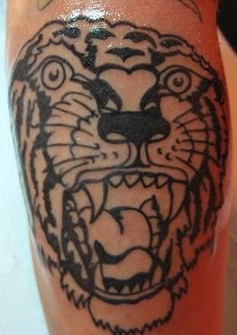 Black ink roaring tiger tattoo
