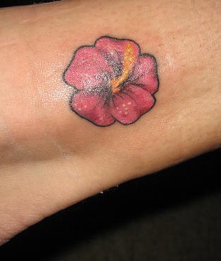 Tiny pink hibiscus tattoo