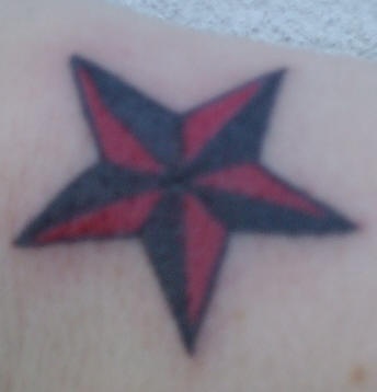 el tatuaje sencillo de una estrella nautica de color negro con rojo