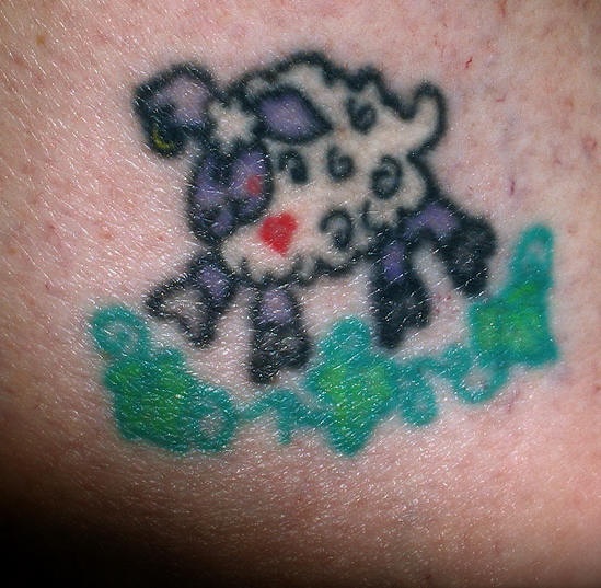Tiny cartoonish sheep tattoo