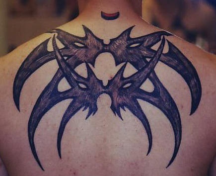 Tribal spider tattoo on upper back