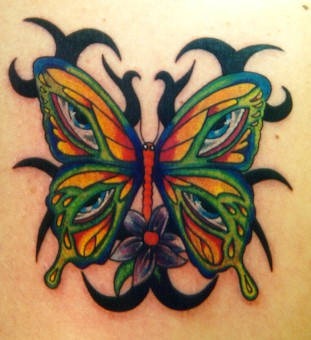 Tribal butterfly with eyes in wings tattoo