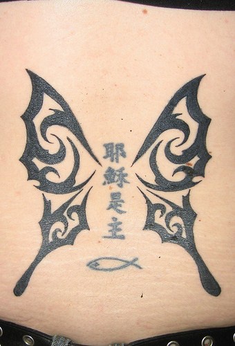 Le tatouage de papillon tribal aillé avec des hiéroglyphes
