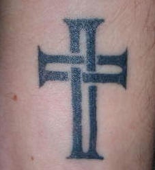 Minimalistic cross tattoo