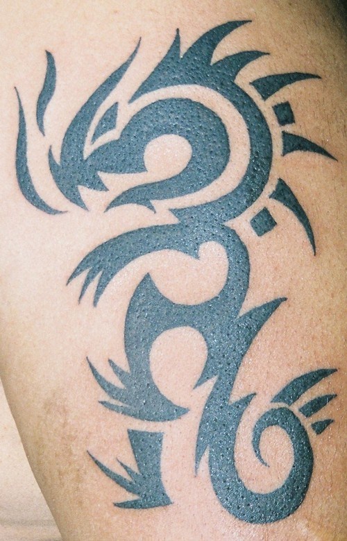 Minimalistic tribal dragon tattoo