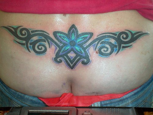 Lower back tattoo,blue, light, flower