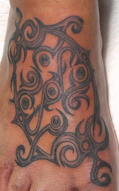 Tribal foot tattoo with circle details
