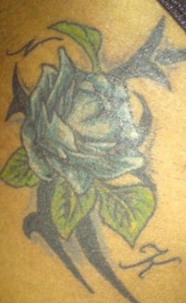Tribal friendship symbol with flower tattoo