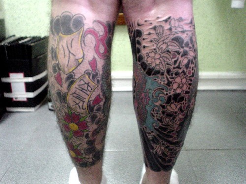 Leg tattoo,many different flowers in pattern
