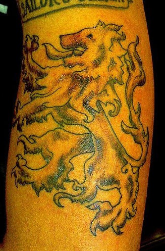 Golden rampant lion tattoo