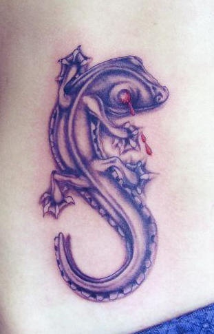 Realistic lizard with blood in eyes tattoo