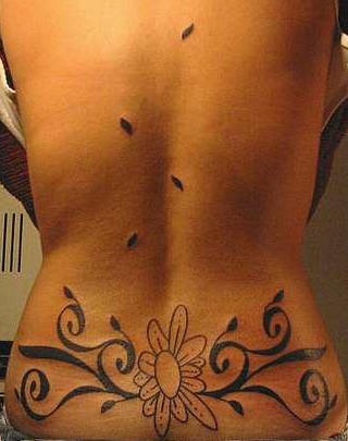 Tribal lower back tattoo,black and white flower designed