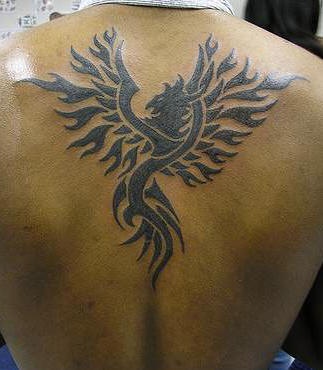 Tribal phoenix black ink tattoo on back
