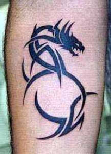 Leg tattoo of black tribal dragon